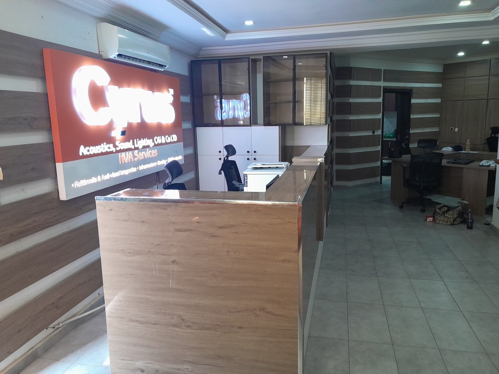 Executive office setting with modern desk, chairs, and natural tones