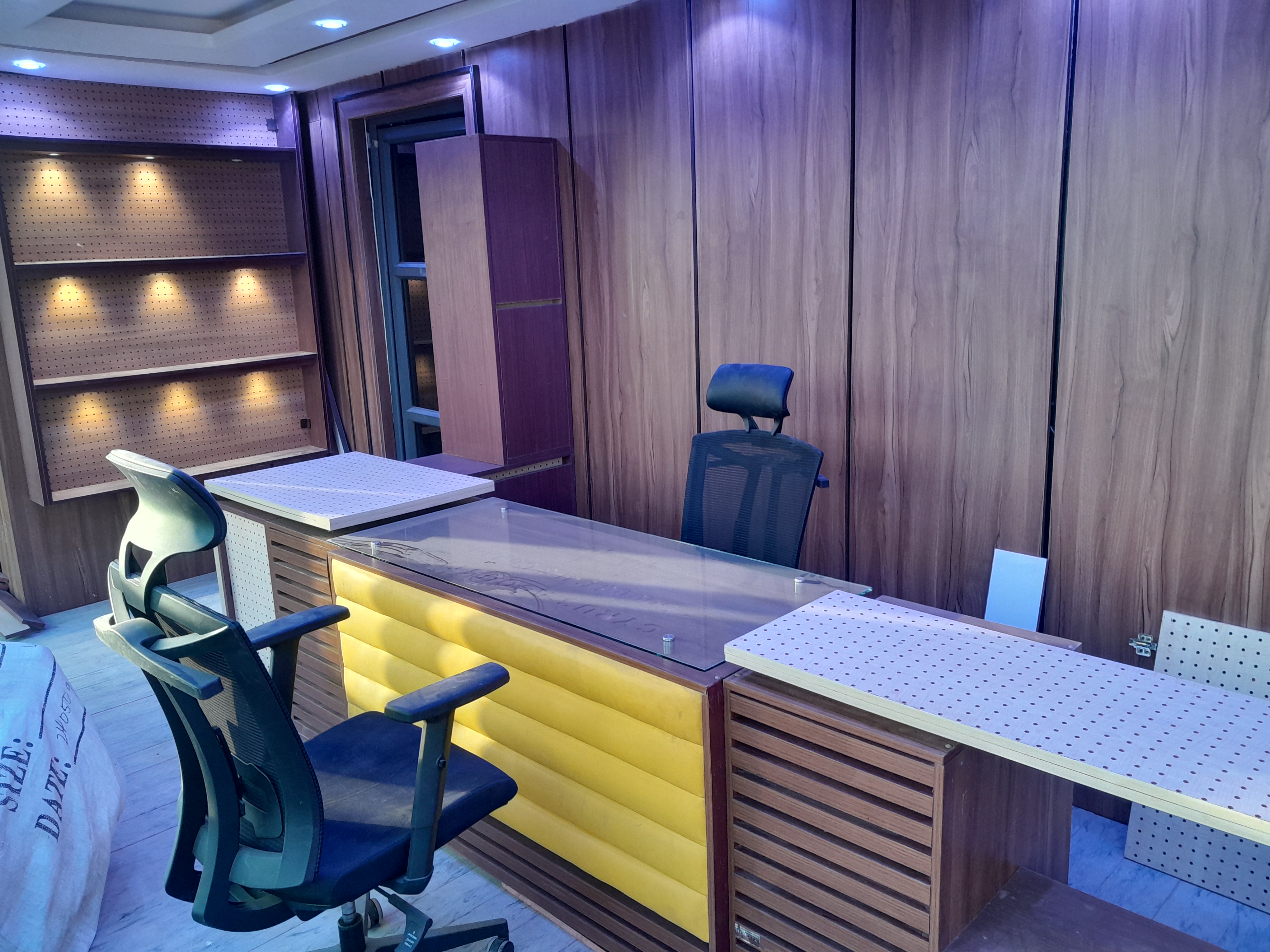 Executive office setting with modern desk, chairs, and natural tones